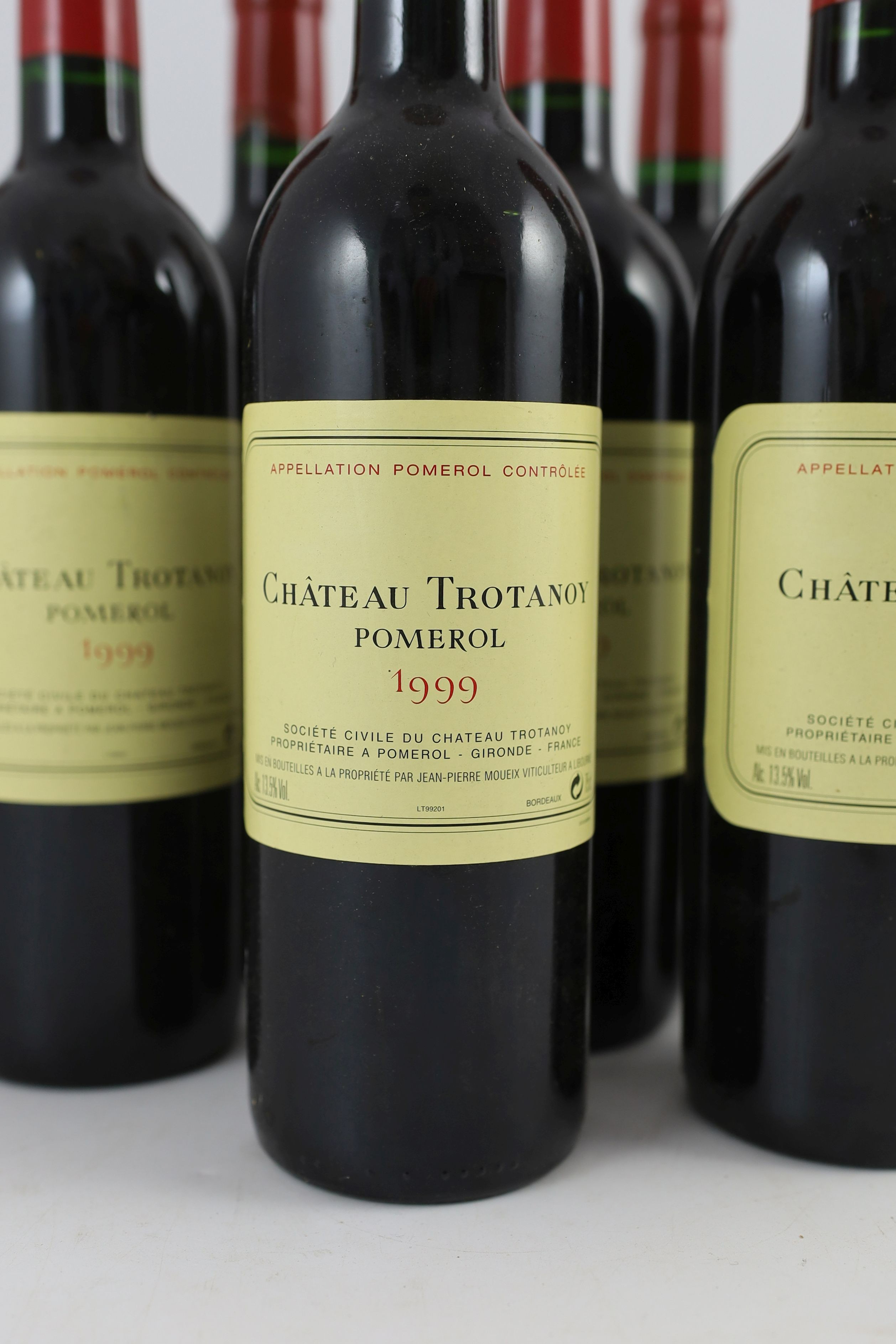 Nine bottles of Chateau Trotanoy Pomerol 1999, height 30cm